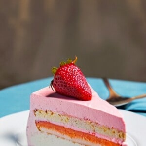 strawberry mango ice cream torte cake. a beautiful cake with red and yellow fruit.
