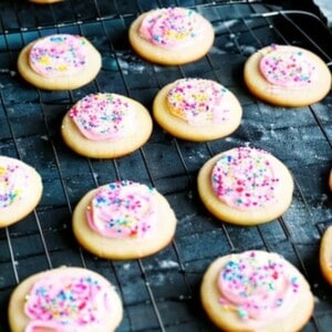 low fat lofthouse cookies are sugar cookies topped with pink frosting and sprinkles.