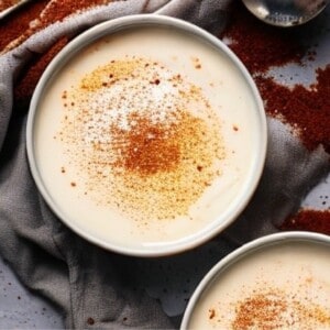 A close-up photo of a bowl of Turkish milk pudding. The pudding has a smooth, custard-like texture