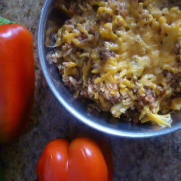 spanish rice and quinoa dinner with red bell pepper green bell pepper cheddar cheese