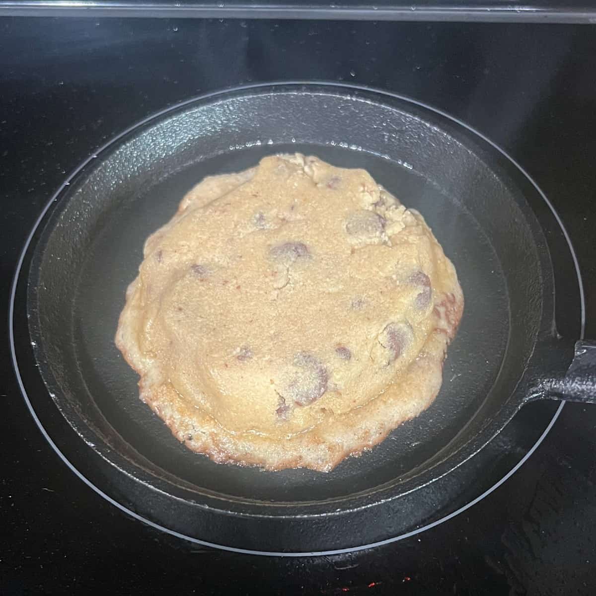 stovetop chocolate chip cookie cooking in a mini skillet