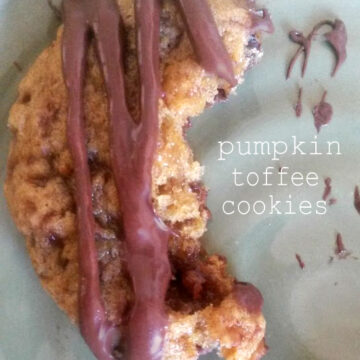 Delicious homemade pumpkin toffee cookies with a soft, chewy texture. These golden-brown treats are studded with sweet toffee bits and have a warm, spiced aroma. The cookies are perfectly shaped, showcasing their crackly tops and enticing caramel-colored edges