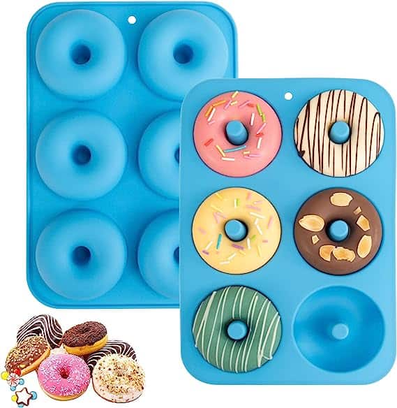 picture of a silicone baked donut mold with different colored donuts decorated insde each mold. The molds are blue and bend easily. 