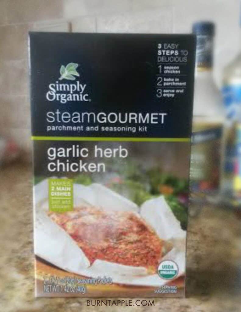a box of simply organic steam gourmet with garlic and herb packets and parchment paper for easy meat roasting