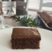fA rectangular chocolate cake with a chocolate frosting on a baking sheet. this recipe is a traditional texas sheet cake recipe.