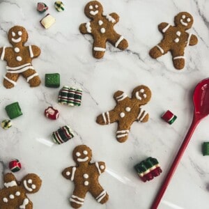 The gingerbread cookie cutter suggests that the viewer is about to bake a batch of delicious gingerbread cookies without molasses. The thick, sticky gingerbread cookie dough looks inviting and makes the viewer's mouth water. The blurred background creates a sense of focus and intimacy.