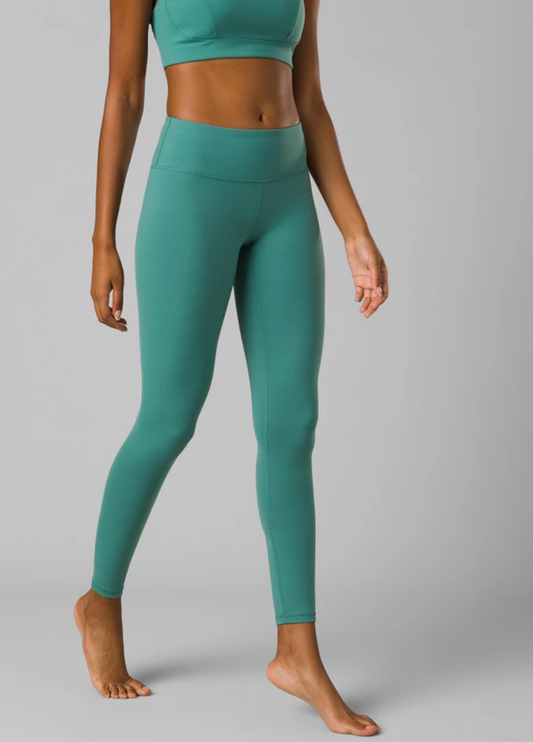 a picture of a woman in prana yoga pants. the pants are green and the person is wearing a sports bra. 