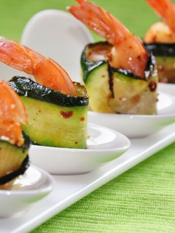 Chunks of juicy shrimp and ribbons of grilled zucchini, artfully arranged on skewers and ready to be devoured