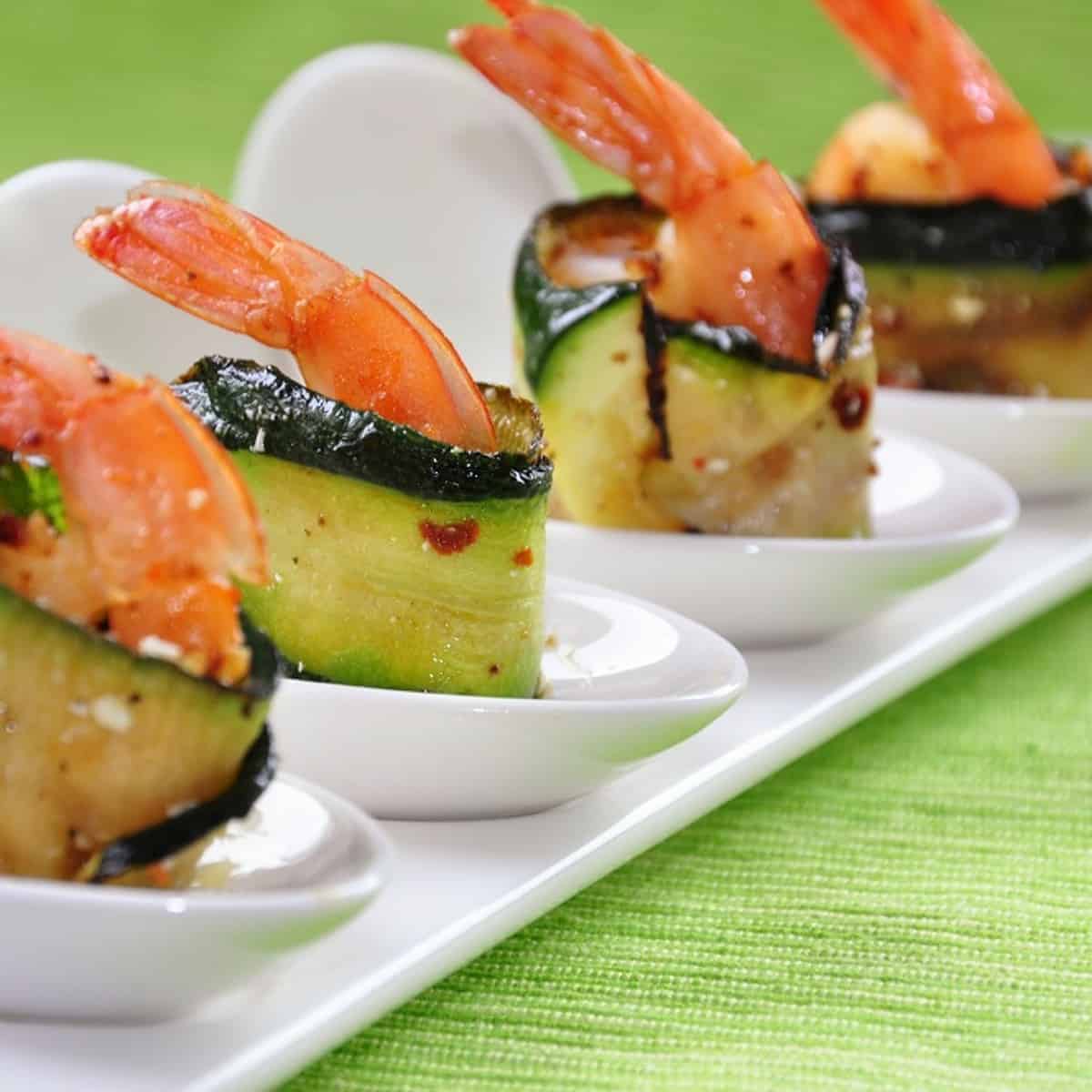 Chunks of juicy shrimp and ribbons of grilled zucchini, artfully arranged on skewers and ready to be devoured