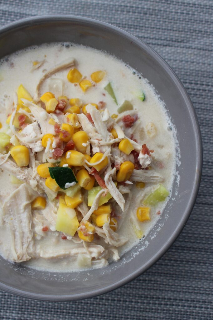 A delicious vegetable corn chowder recipe with chicken, squash, corn, cream and fresh herbs and spices.