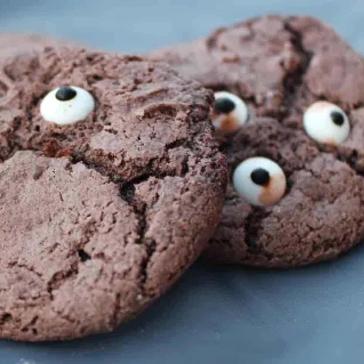 A close-up photo of a gluten-free monster cookie's candy eyeball, its shiny surface and realistic details