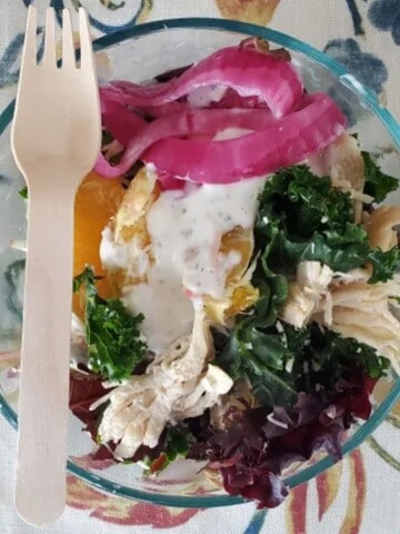 souvla san francisco souvla salad made with chicken, orange, pickled onion, Greek yogurt and spices.