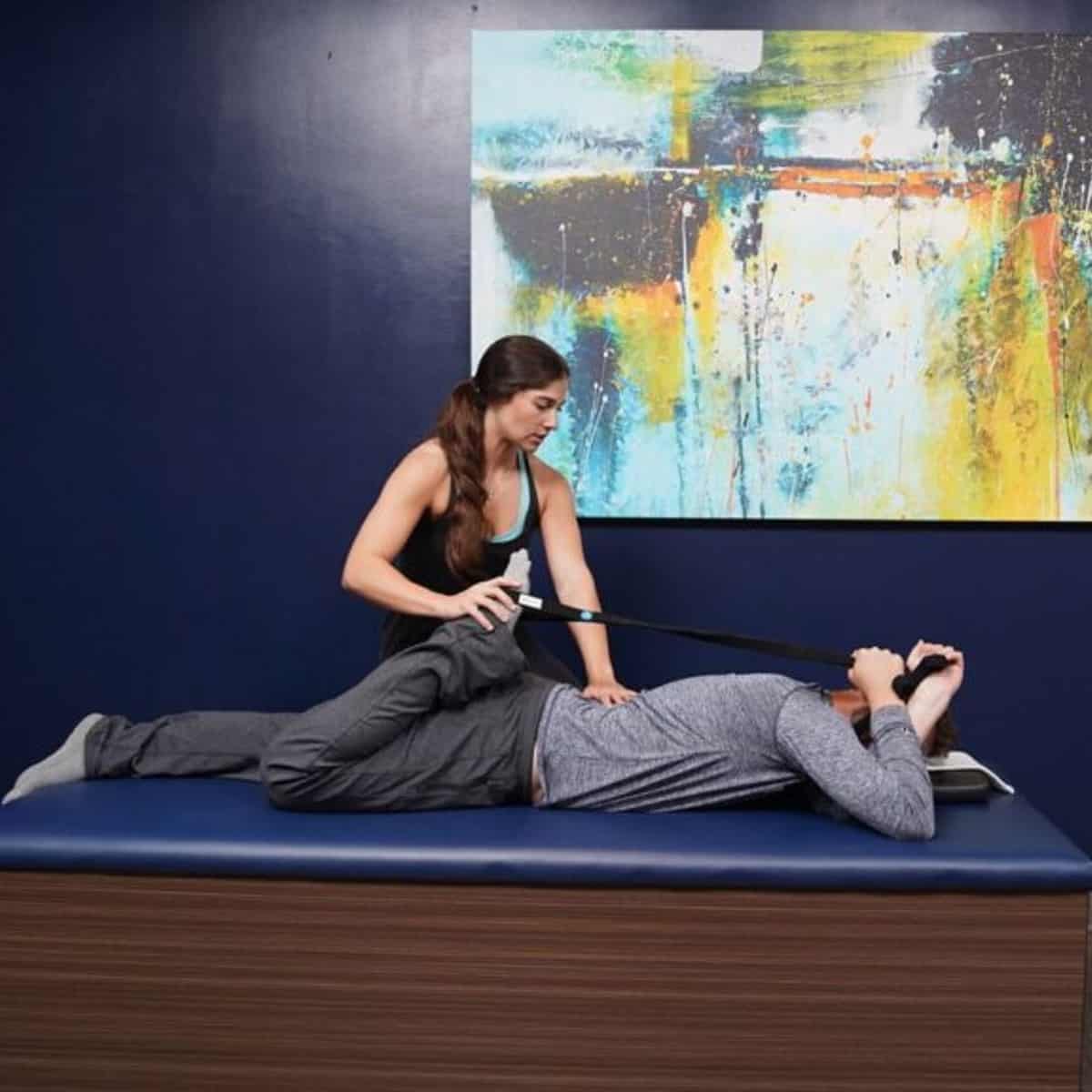 a picture of a flexologist performing an assisted stretch on a client. 