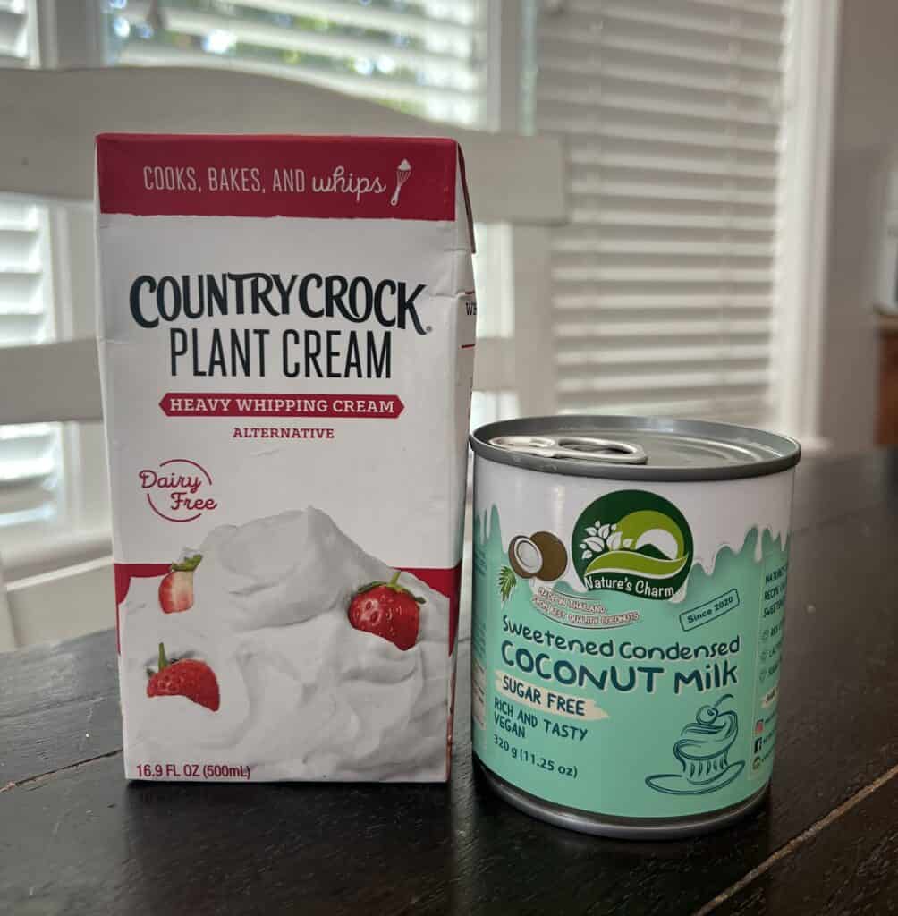 dairy free heavy whipping cream and dairy free sweetened condensed milk are pictured. they are both plant based, lactose free and sugar free alternatives. 