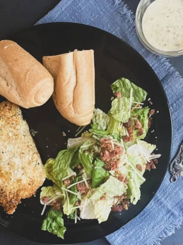a photo of Baked Breaded Pork Chops Recipe with cut crust bread and a salad.