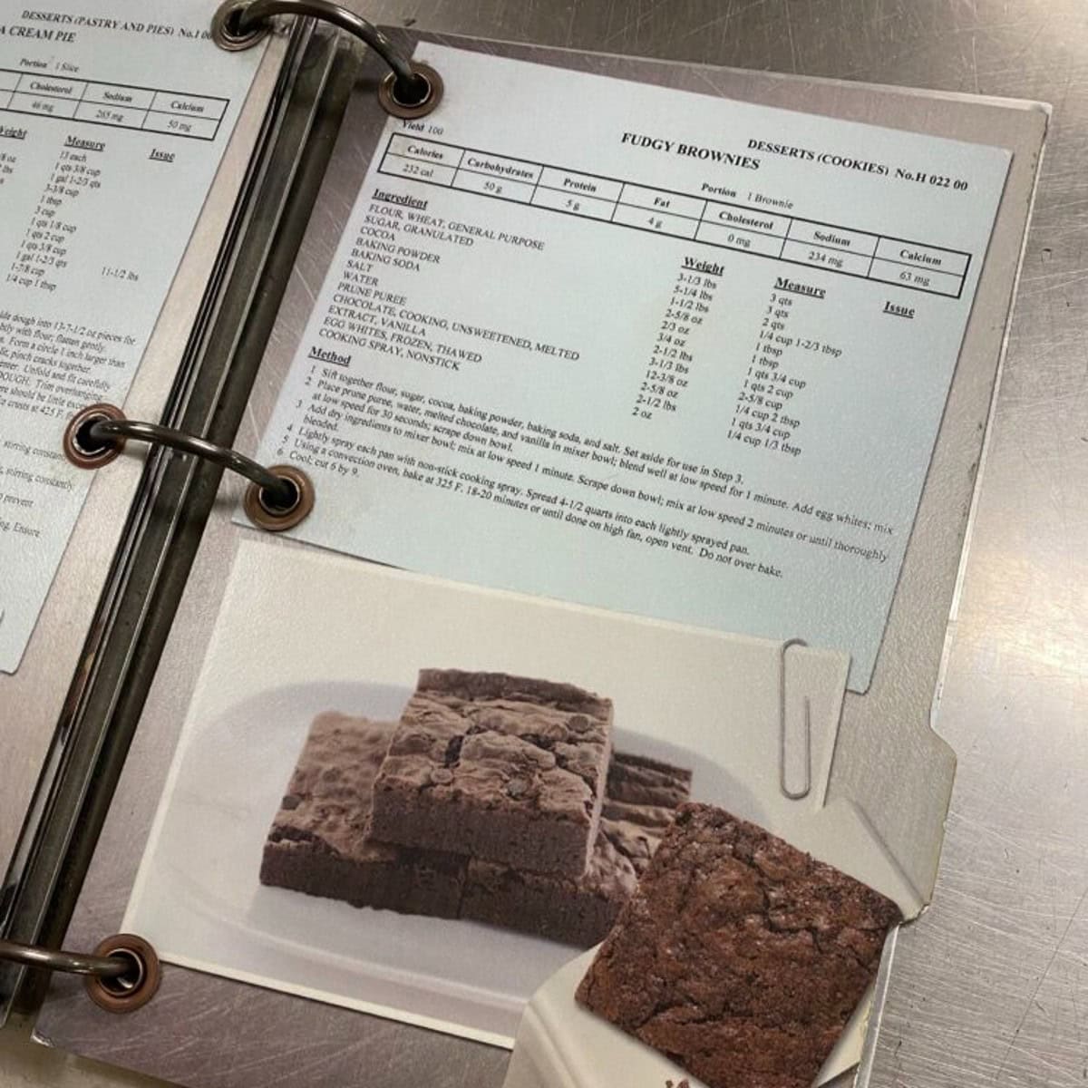 a picture of a cookbook on the uss midway with a photo of fudgy prune brownies