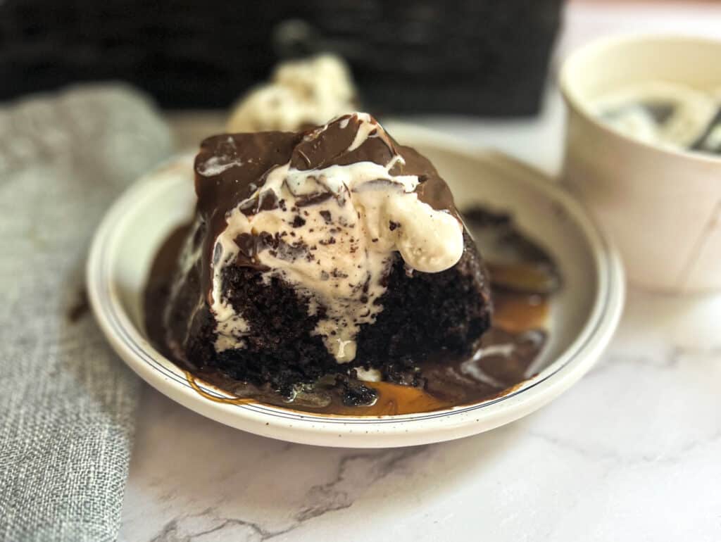 A slice of Chili's Molten Lava Cake with a gooey chocolate center, served with a scoop of vanilla ice cream, caramel sauce and drizzled with chocolate shell. 