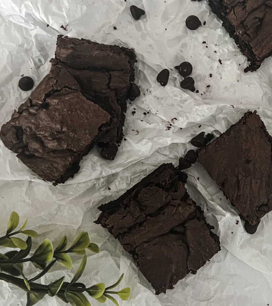 Gooey and decadent brownies made from a rich chocolate cake mix. Each square is filled with fudgy goodness and topped with a dusting of powdered sugar. A tempting delight for chocolate lovers.