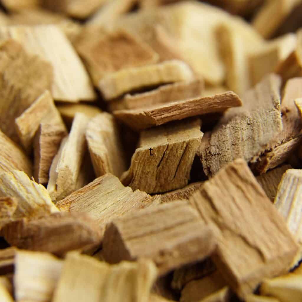 A close-up of a pile of wood chips used for smoking on a gas grill