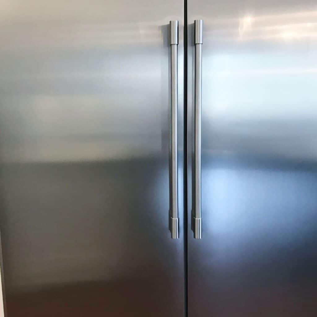 a picture of a stainless steel refrigerator. inside the refrigerator has been organized for food allergies. 