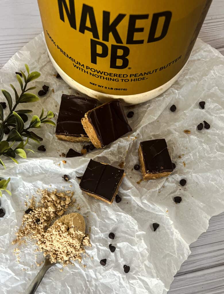 a picture of peanut butter protein powder bars made with naked nutrition protein powder. each bar is topped with a layer of melted chocolate chips. 