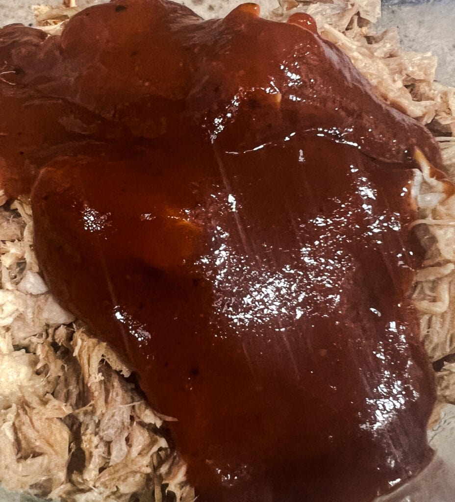 It is made with shredded pork that has been cooked slowly until it is tender and juicy.
The pork is then tossed in a flavorful barbecue sauce.
Pulled pork with barbecue sauce can be served on a bun, in a sandwich, or on its own.
It is a popular dish at barbecues and potlucks.