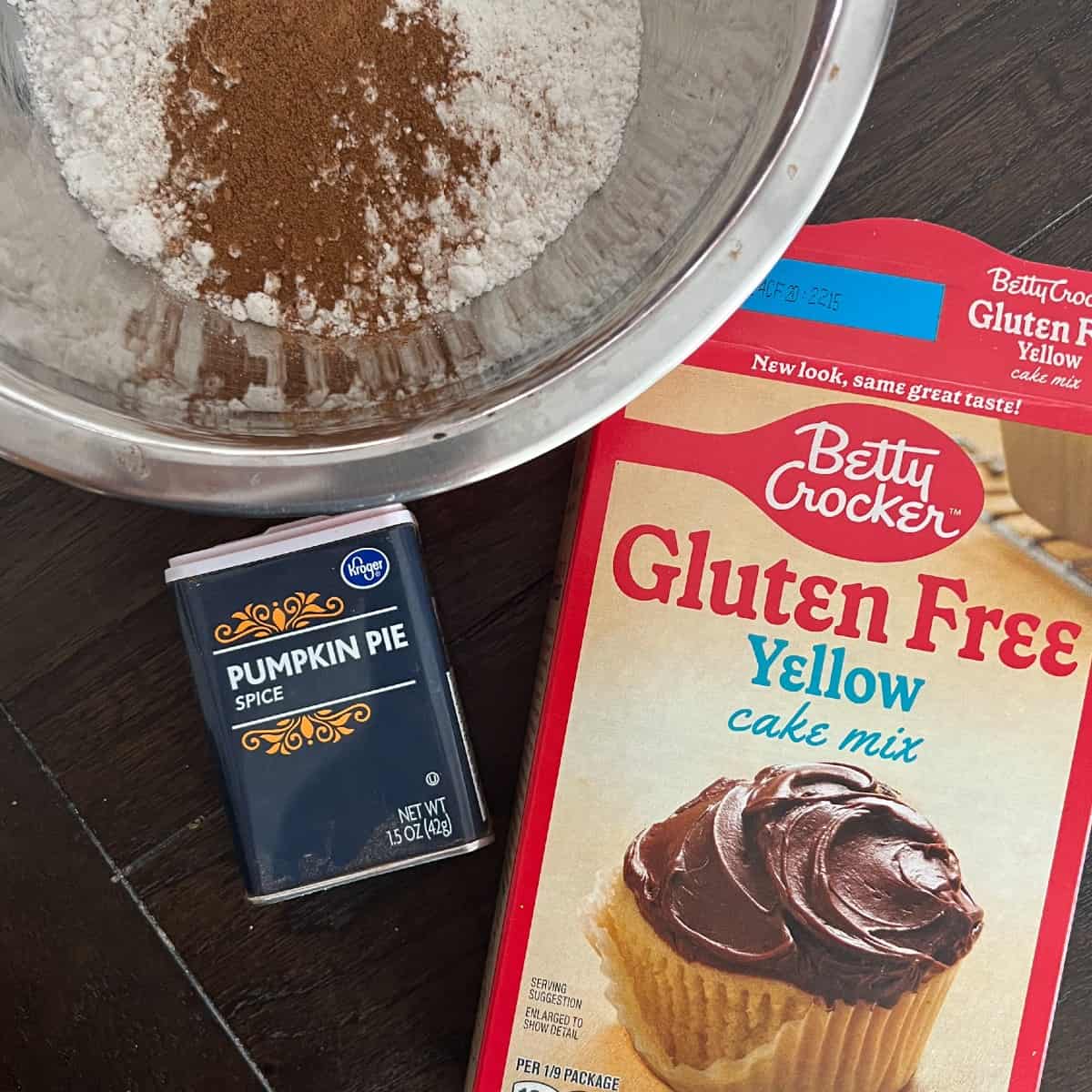 a picture of yellow cake mix and pumpkin spice. The two ingredients combine to make spice cake. 