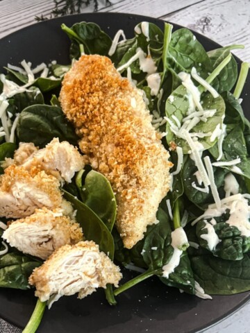 chicken caesar florentine with chicken crushed caesar croutons and parmesan cheese.