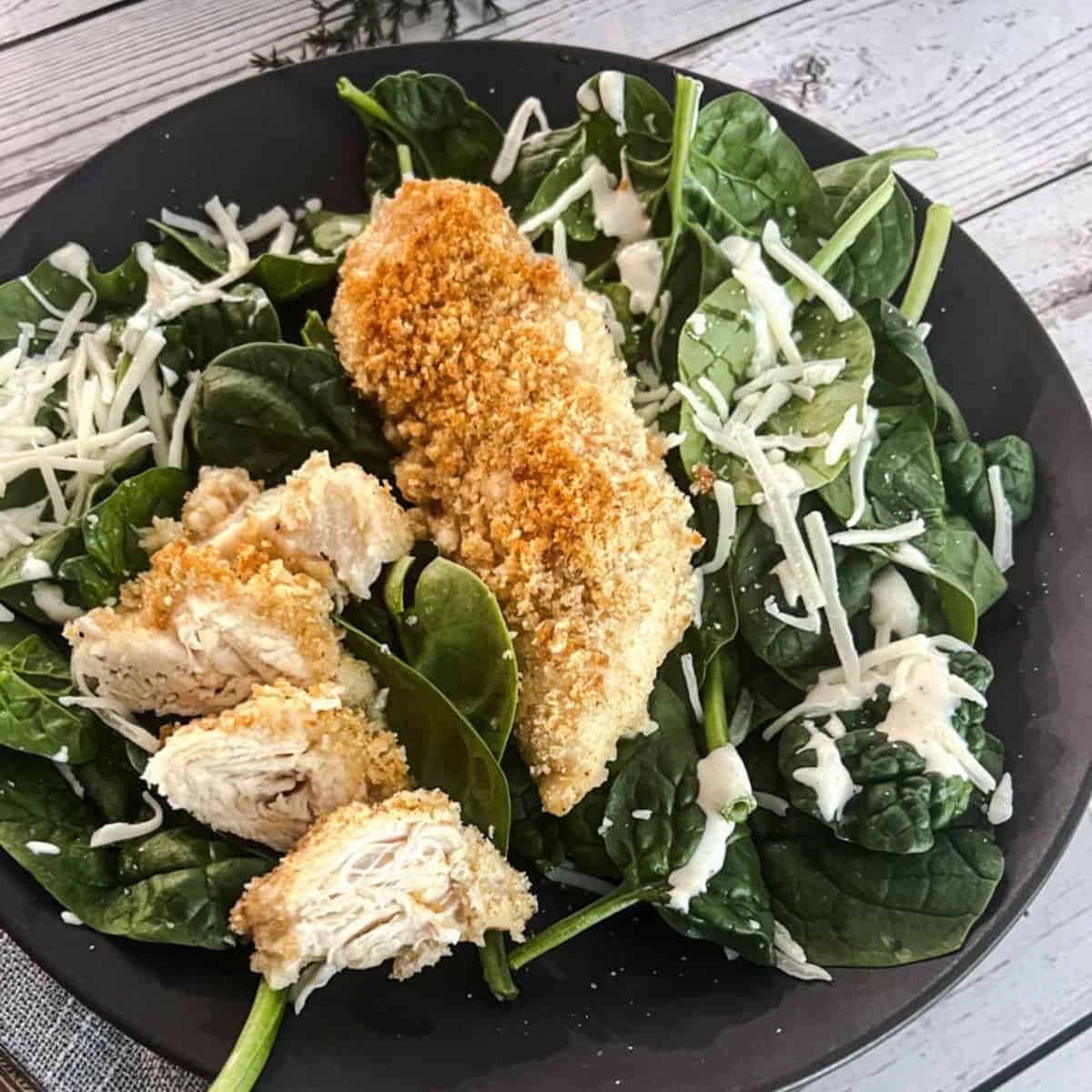 chicken caesar florentine with chicken crushed caesar croutons and parmesan cheese.