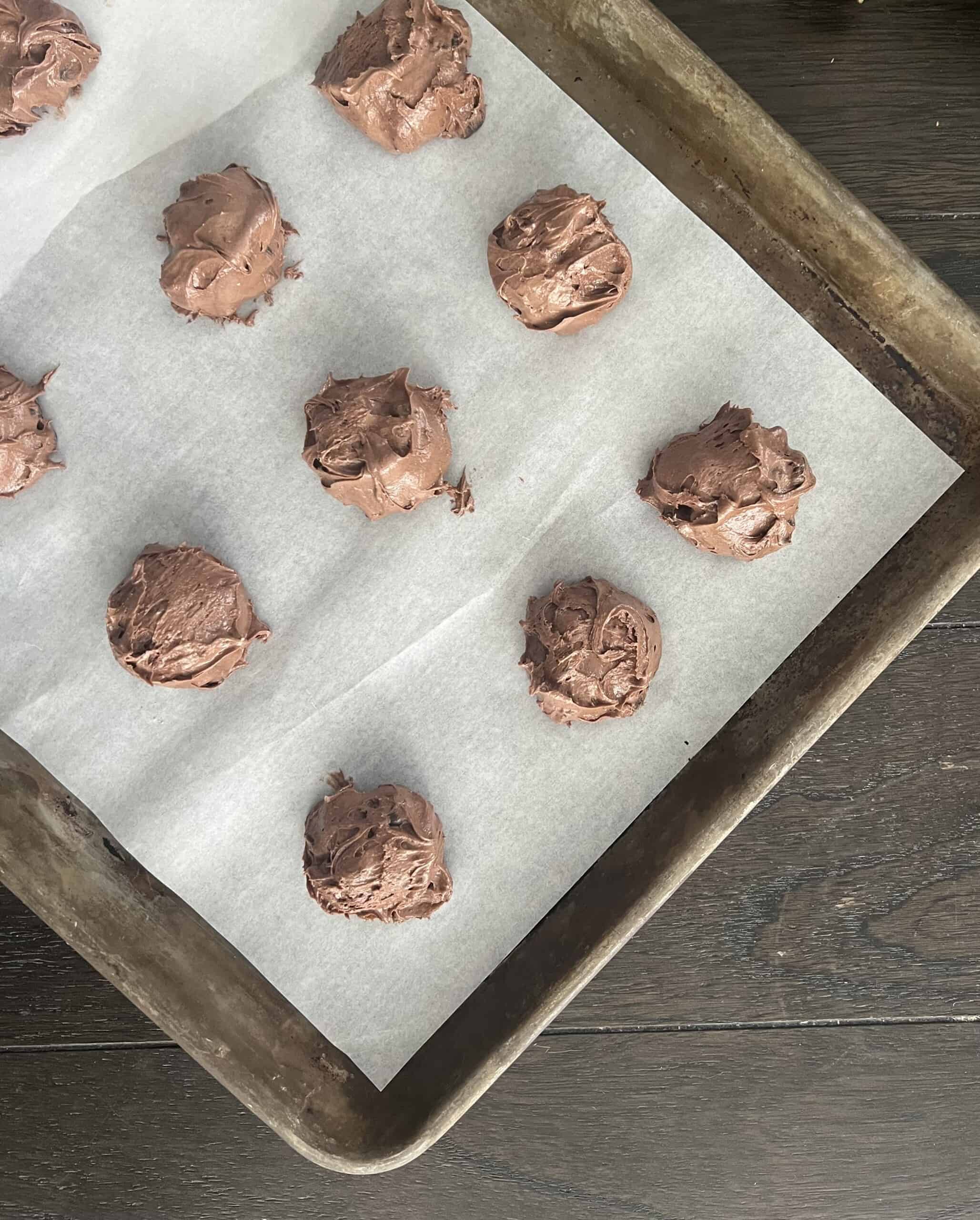 drop chocolate crinkle cookie batter onto a cookie sheet