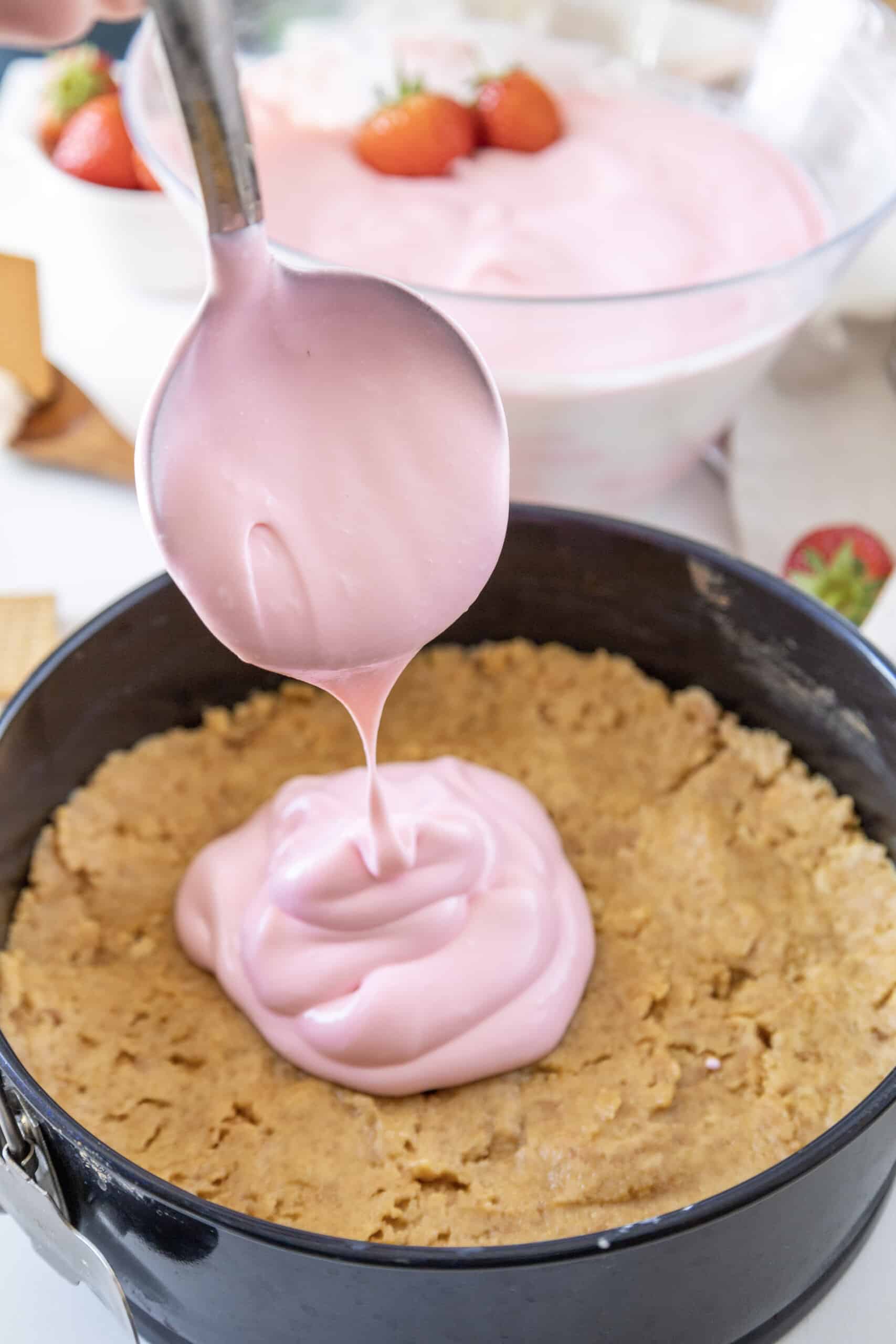 Pour the filling for your Philadelphia no bake strawberry cheesecake into the crust.
