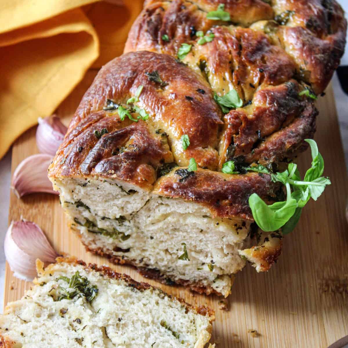 a picture of a delicious loaf of gourmet garlic bread with garlic, butter, and herbs. 