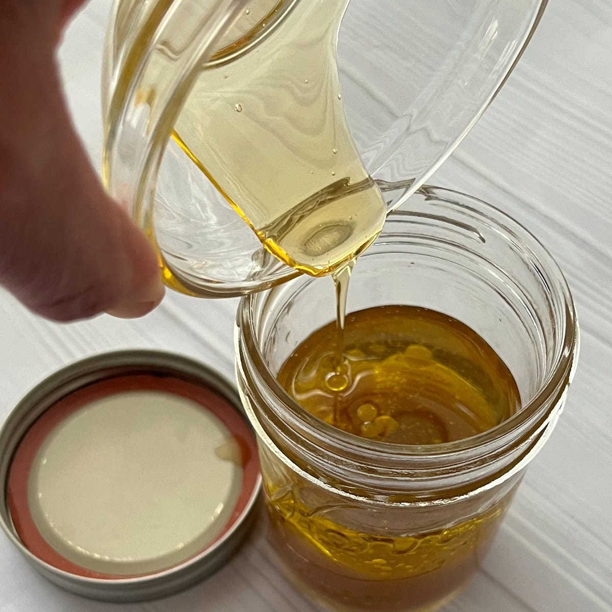 pour zesty apple cider vinaigrette ingredients into a mason jar