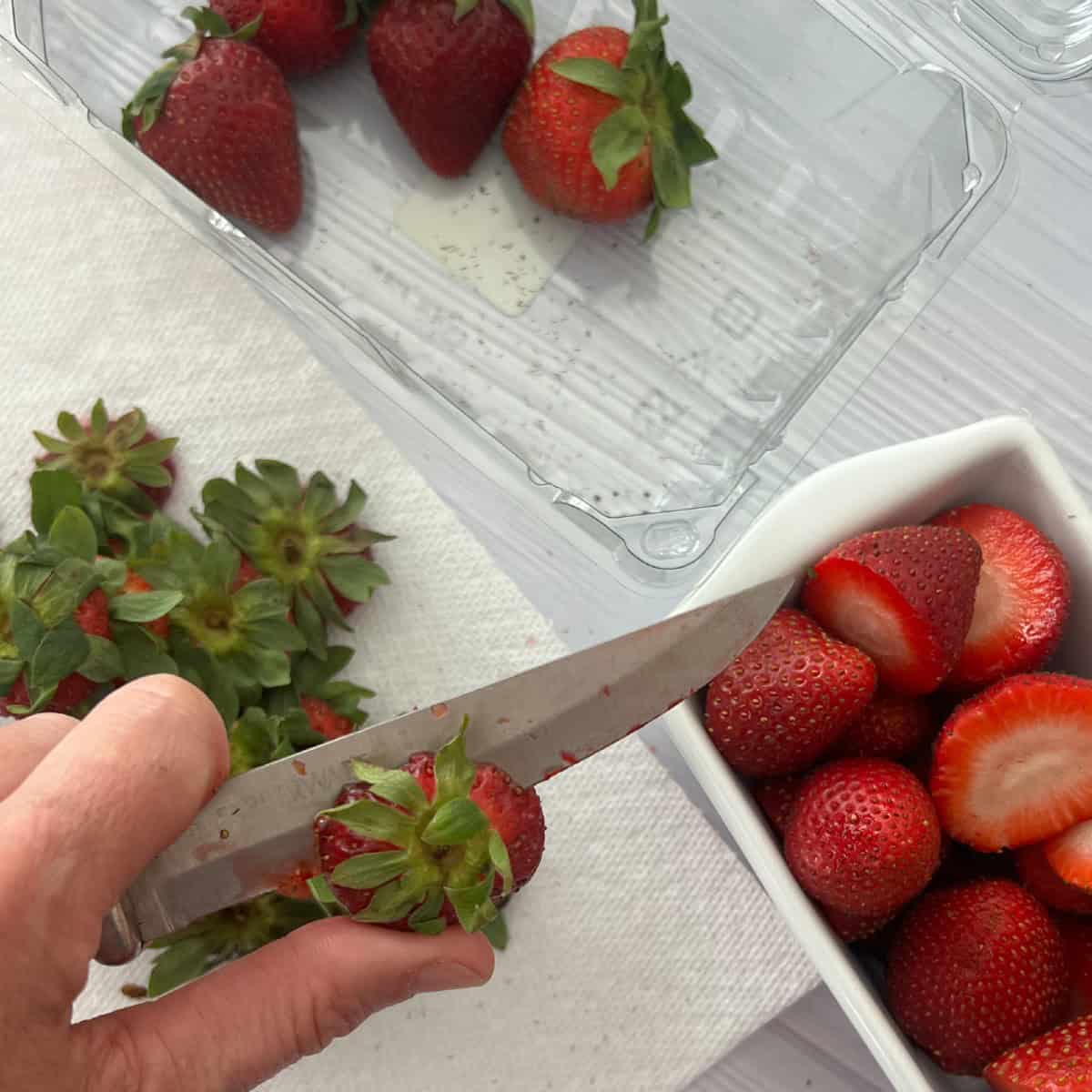 wash and cut off tops of strawberries