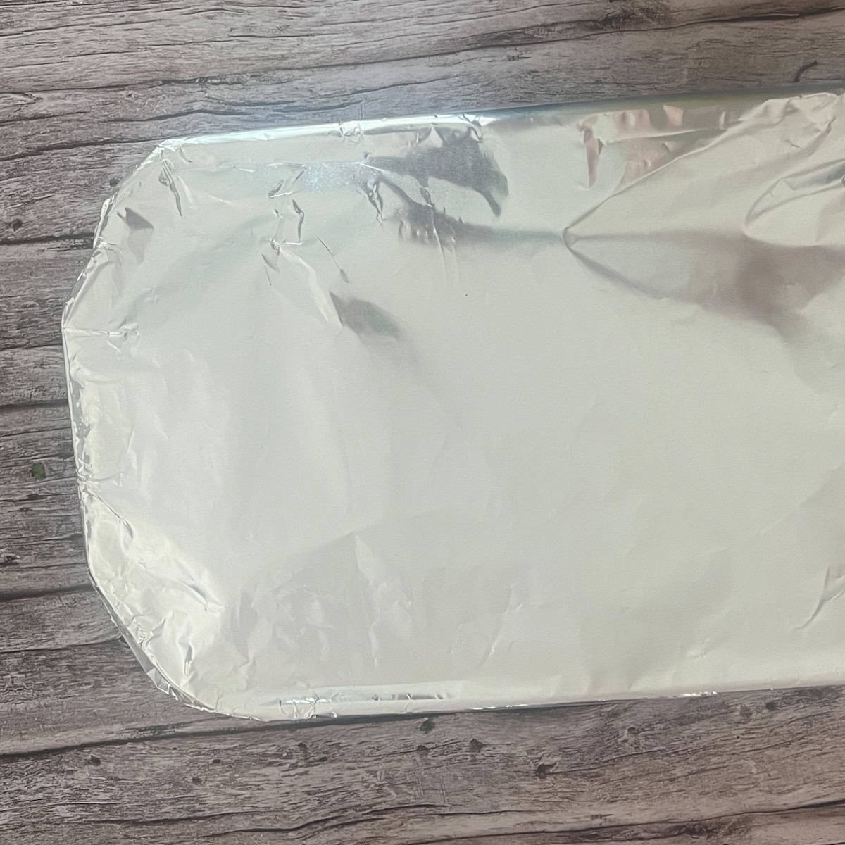 a photo of a baking dish wrapped in aluminum foil