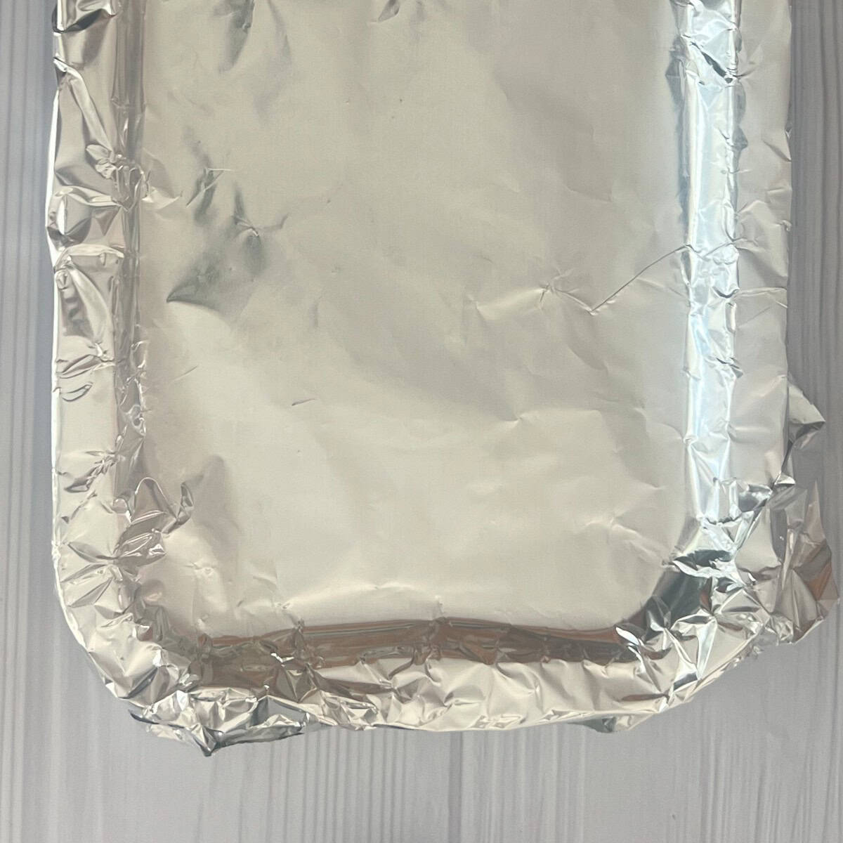 a photo of a baking sheet lined with aluminum foil