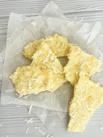 This image appears to be of lemon coconut bark. It's a light-colored, flaky treat with a white base and bits of coconut throughout.