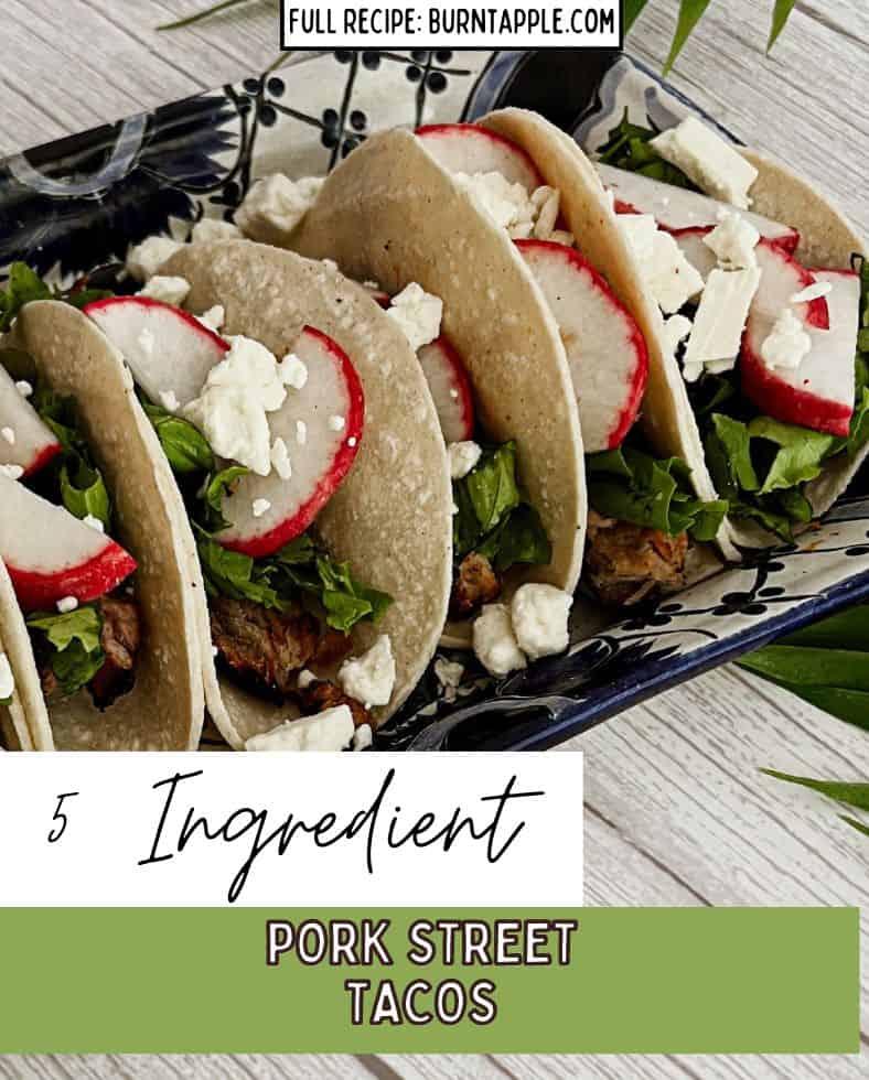 A photo of street tacos with pork and corn tortillas, pulled pork, radishes and cotija cheese.