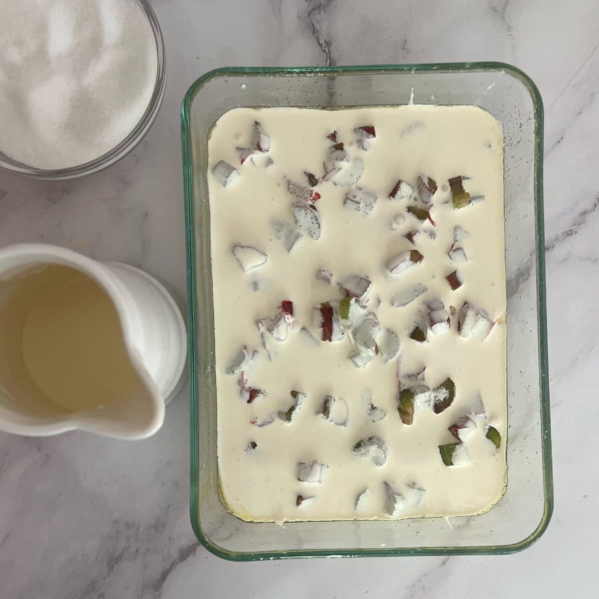 Place cake in the pan. Sprinkle rhubarb on top, then pour cream evenly on top. Bake at 350 degrees. 